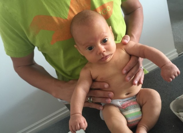 Charlie sporting an Honest Diaper (girl-themed because it was passed down from a friend's daughter).